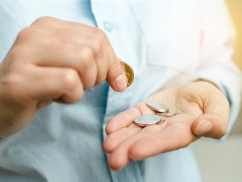 Business finance saving and investment concept. Woman holding silvery coins in her hand
