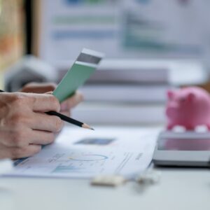 Business man hands holding saving account passbook with calculator, account and saving concept