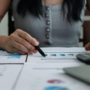 Business woman working in finance and accounting Analyze financial budget with calculator and