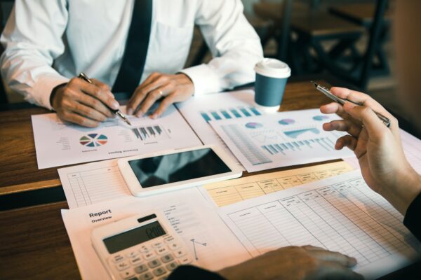 Manager calculates about the company finances by pressing on the calculator on the table